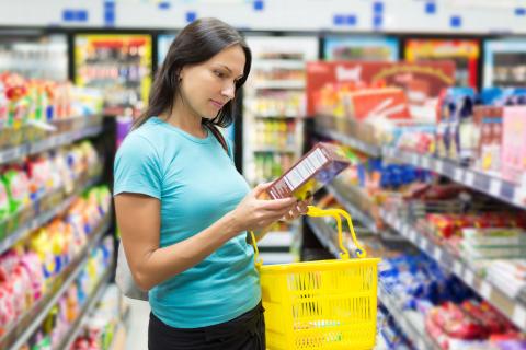 Woman reading Nutrition Facts label